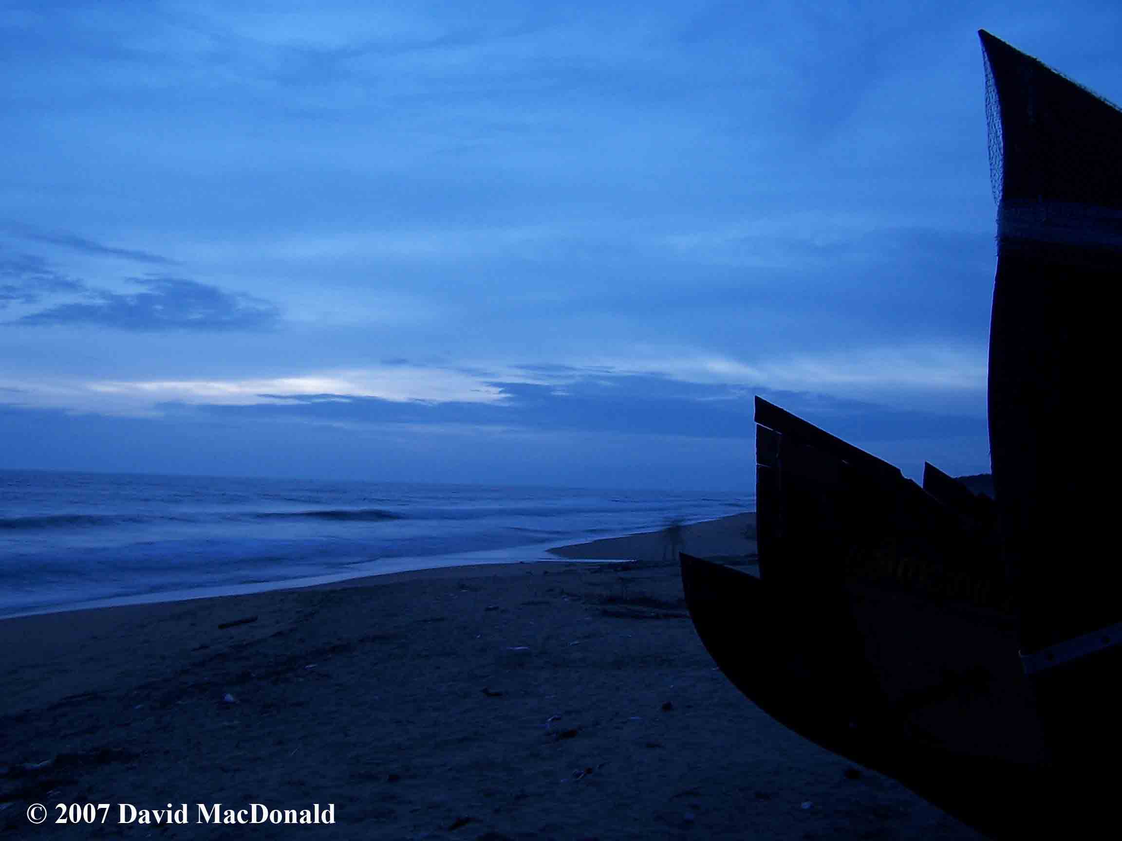 Indian fishing boats on the beach of the Arabian Sea at dusk 